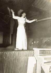Female singing on stage at a USO Show