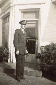 Bill in full uniform standing in front of house